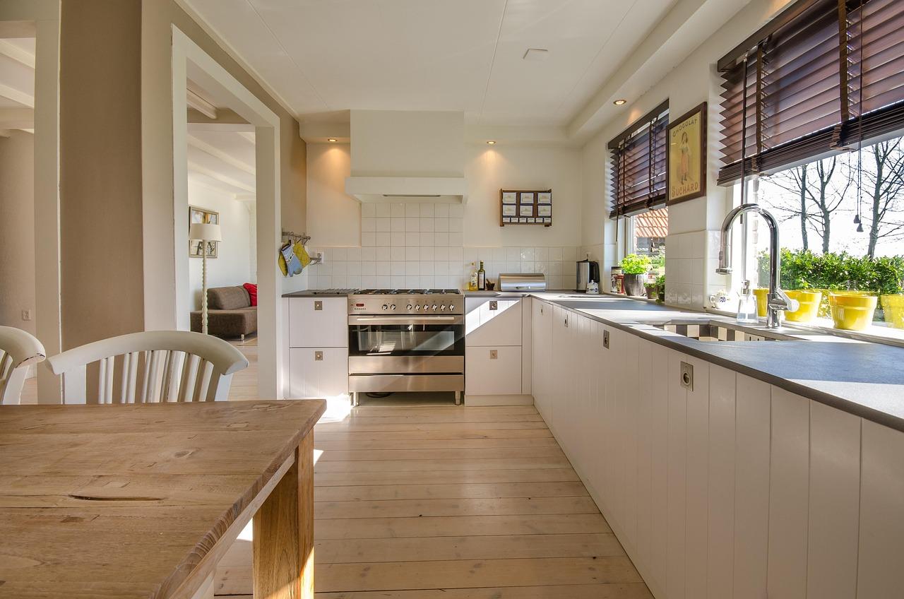 Modern kitchen with glass-front upper cabinet doors displaying dishware